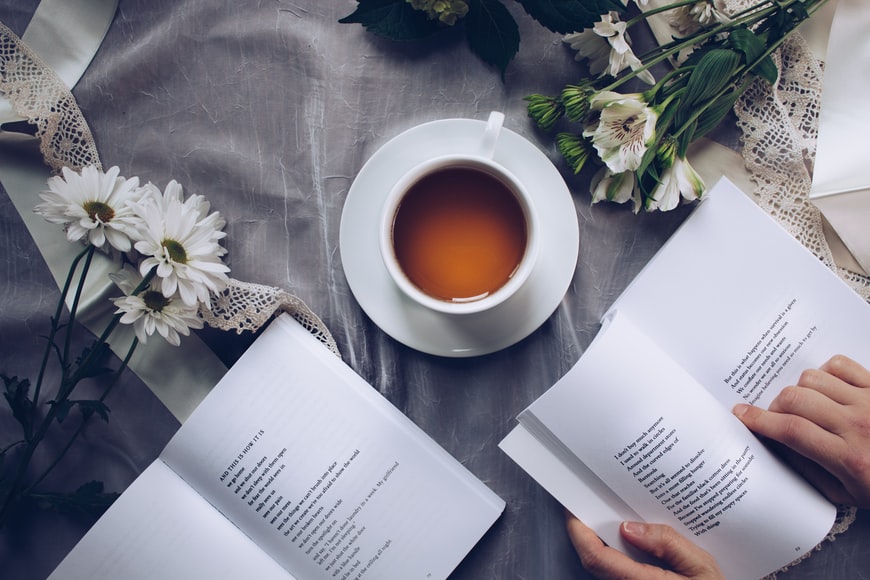 Self advocacy skills two books and a mug of coffee on a table decorated with white flowers 