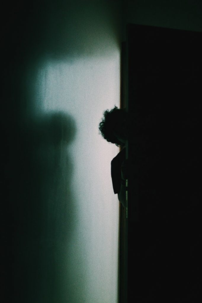 Silhouette of a persons shadow in a dark room 