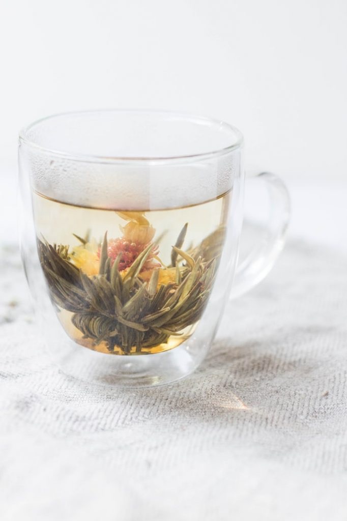 Glass mug filled with herbal tea flowers 