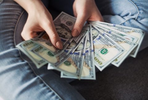 Tips for salary negotiation person holding multiple hundred dollar bills