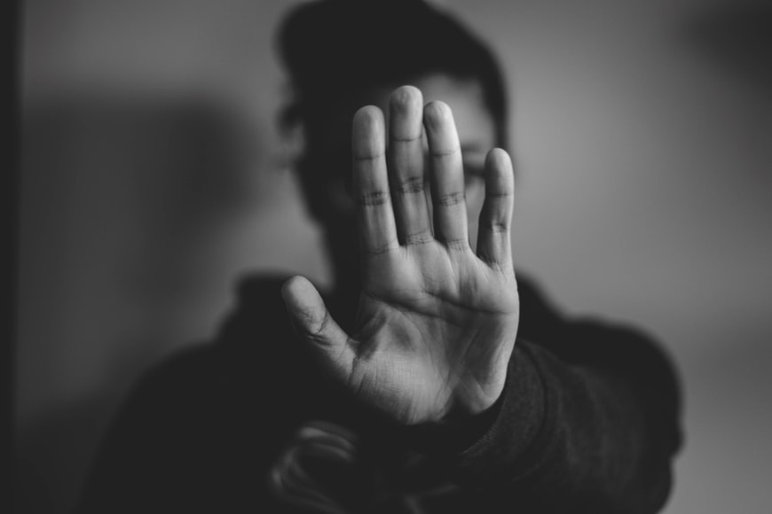 Healthy boundaries, black and white photo of a woman with her hand up in front of her 