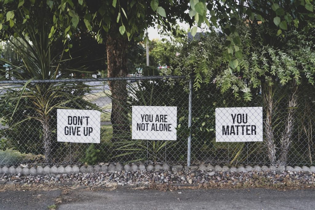 Affirmations posted to a fence 