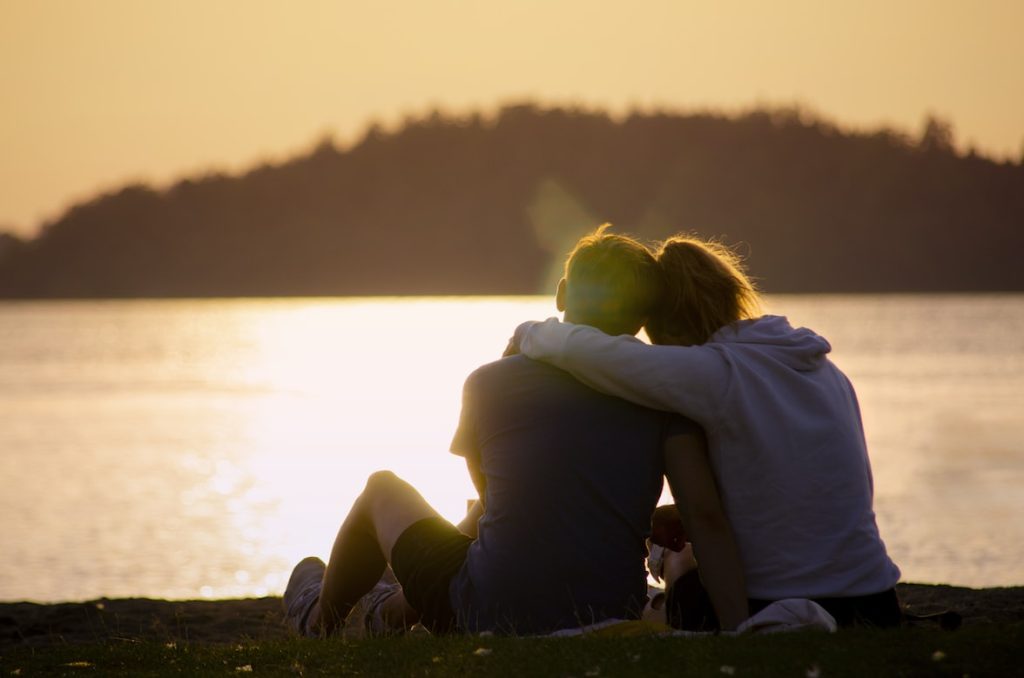 Couple sitting by a lake 