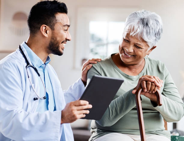 Young doctor consoling older patient 