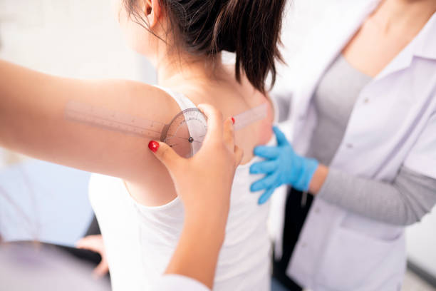 Physiotherapist is measuring a plastic prosthesis on a patient's shoulder